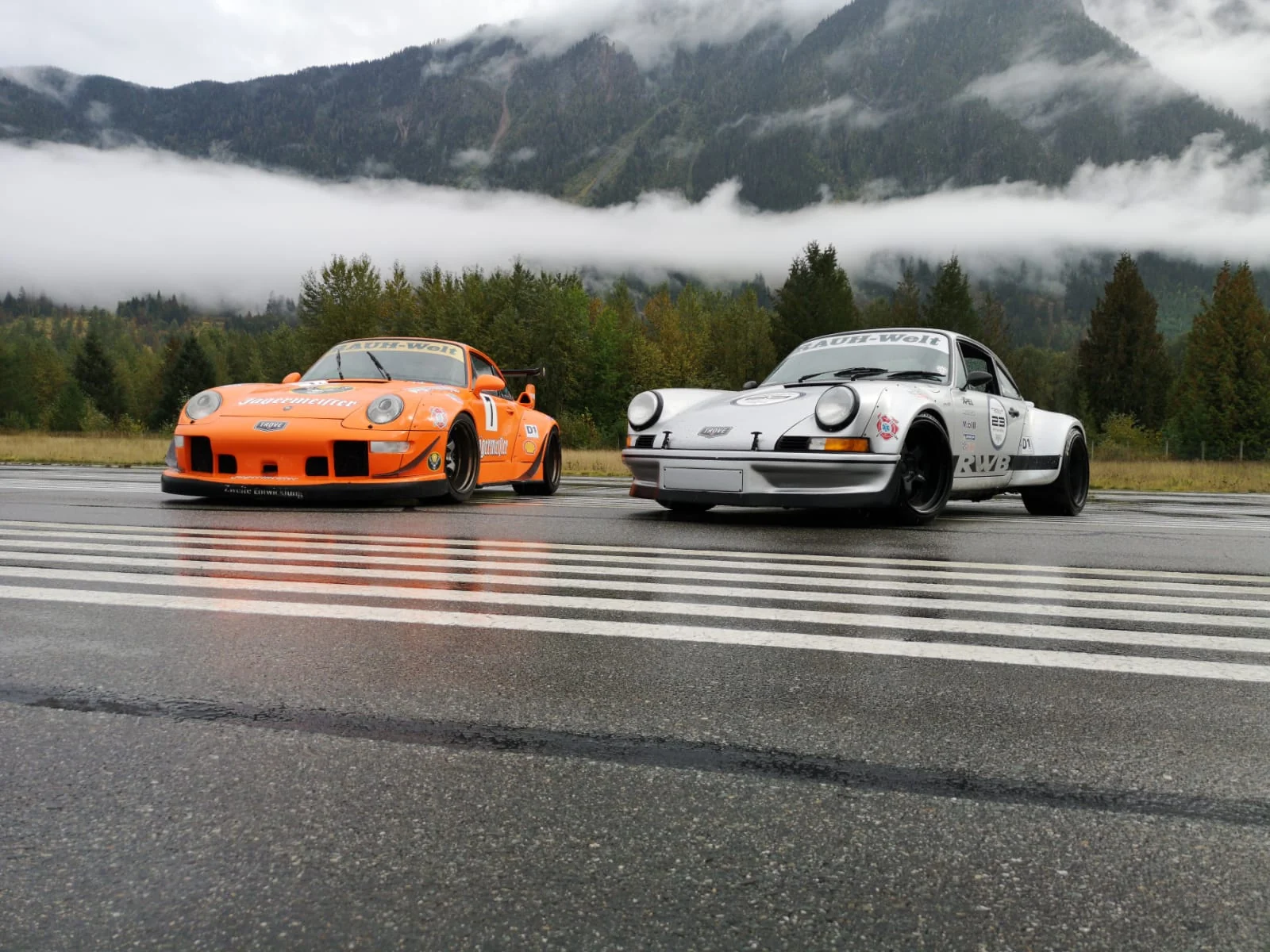 RWB Jägermeister and a white 911 on a misty mountain runway